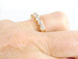 a woman ' s hand with a diamond ring on it