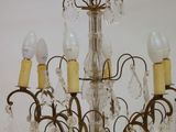 a chandelier that has five lights hanging from it
