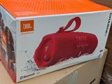 a box with a red speaker on top of a cardboard box