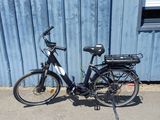 a bike that is parked in front of a blue building