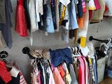 a lot of clothes hanging on a rack in a room