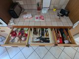 a drawer full of tools on the kitchen floor