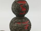 a red and black lamp with a dragon design on it