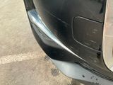 a close up of a car ' s front bumper with a hole in it