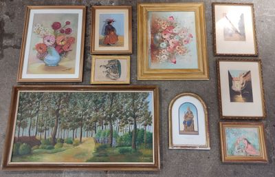 a lot of framed pictures on the floor of this room