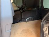 the interior of a van with the door open and the driver ' s seat down