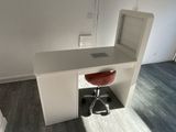 a desk with a chair and a computer on it