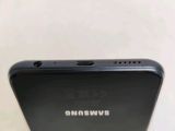 a close up of the back of a black samsung phone