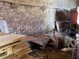 a pile of wood in a room with a brick wall