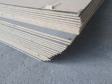 a close up of a stack of plywood boards on the ground
