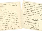 a close up of two papers with handwriting on them