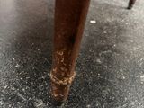 a close up of the legs of a wooden table on the floor