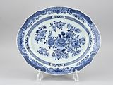 a blue and white plate with a floral design on it