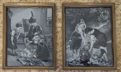 two framed pictures of a couple of people on a wall