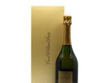 a bottle of champagne in front of a gold box