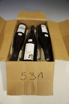 three bottles of wine in a cardboard box on a table