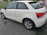 a picture of a white car parked in a parking lot