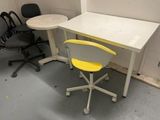 a white table with a yellow chair next to it