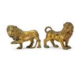 pair of bronze lion figurines on white background