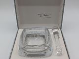 an image of a glass ashtray in a box with a spoon and a glass ashtray in it