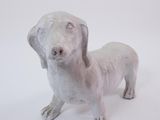 a small statue of a dog on a white background