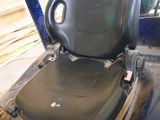 a black seat on the back of a forklift