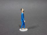 a small figurine of a man in a blue suit
