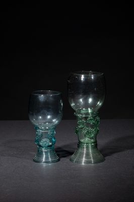 two glass goblets sitting on a table