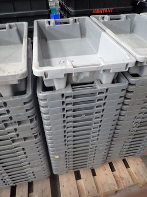 many plastic containers stacked on a pallet in a store