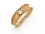 a close up of a gold bracelet on a white background
