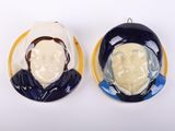 pair of blue and white ceramic portraits of a man and a woman