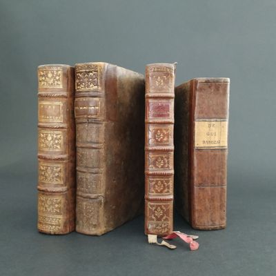 three old books that are sitting on a table