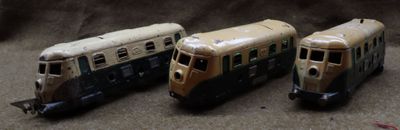 three toy trains sitting next to each other on a table