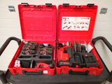 two red tool boxes with tools in them sitting on a cart