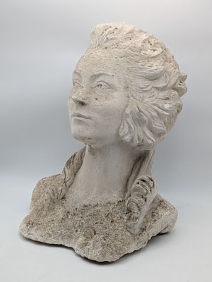 sculpture of a woman ' s head on a rock with a white background