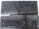 two keyboards sitting next to each other on a table