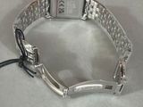 a silver watch that is sitting on a table