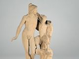 statue of a man and a woman with a bird on a rock