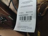 several pairs of shoes are stacked on top of each other with a price tag