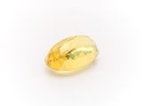 a yellow sapphire stone on a white background