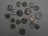 several ancient roman coins are arranged in a circle on a table
