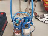 a blue cart with two cylinders on it in a room