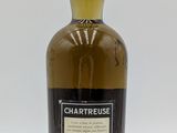 a close up of a bottle of whisky on a white surface