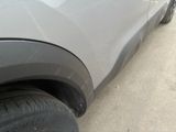 a close up of a car ' s tire on the side of the road
