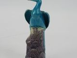 a blue bird that is sitting on top of a tree stump