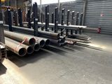 many steel pipes in a large warehouse area