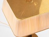 a gold lamp that is sitting on a table