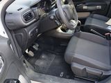 the interior of a car with the door open and the driver ' s seat down