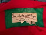 a red jacket with a label on it and a green and white checkered jacket