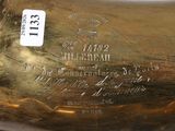 a gold vase that has a label on it